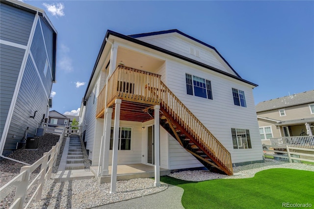 rear view of property with a yard and a patio