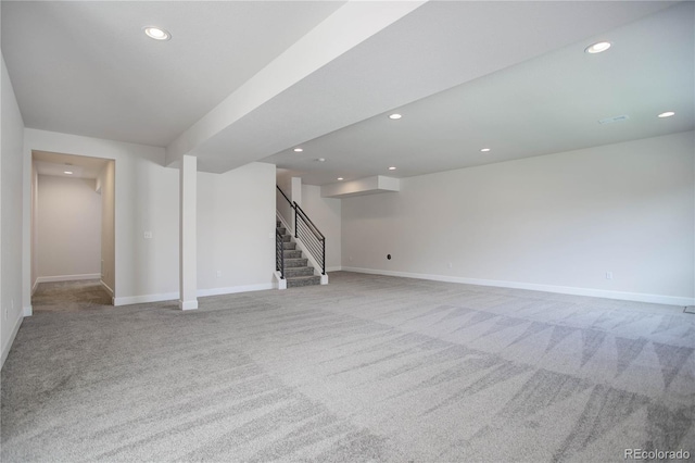 unfurnished living room with light colored carpet