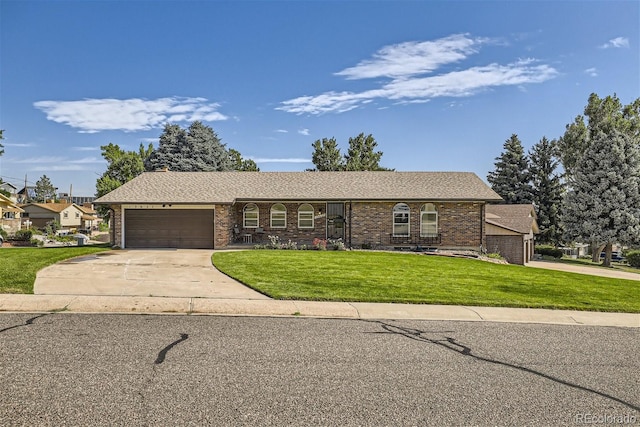 ranch-style home with a garage and a front lawn