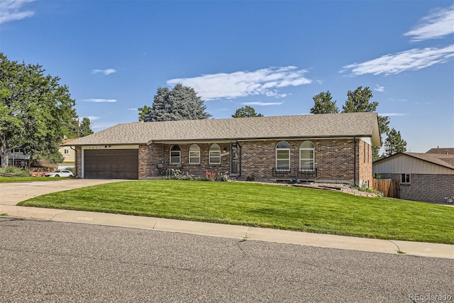 ranch-style home with a front yard and a garage