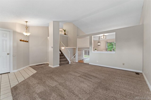 11532 Newland St, Westminster, CO 80020 - unfurnished room featuring vaulted ceiling, carpet floors, tile patterned floors, and stairway