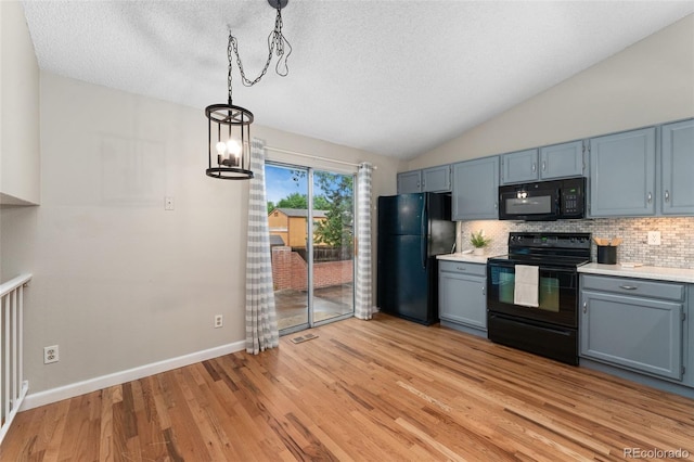 11532 Newland St, Westminster, CO 80020 - kitchen featuring black appliances, backsplash, light countertops, a textured ceiling, and light wood-type flooring