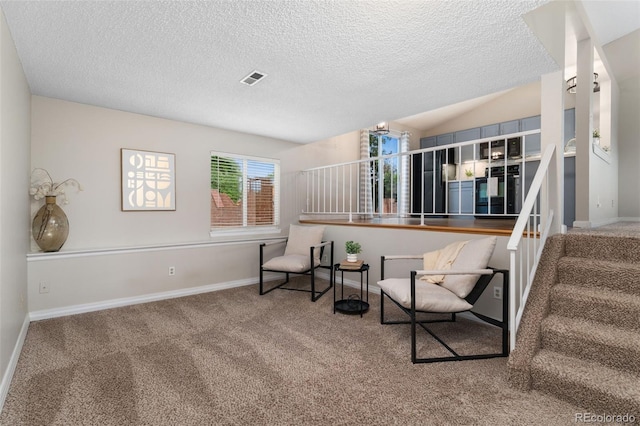 11532 Newland St, Westminster, CO 80020 - sitting room featuring carpet flooring, stairway, a textured ceiling, and lofted ceiling