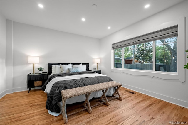 bedroom with recessed lighting, baseboards, and light wood-style floors