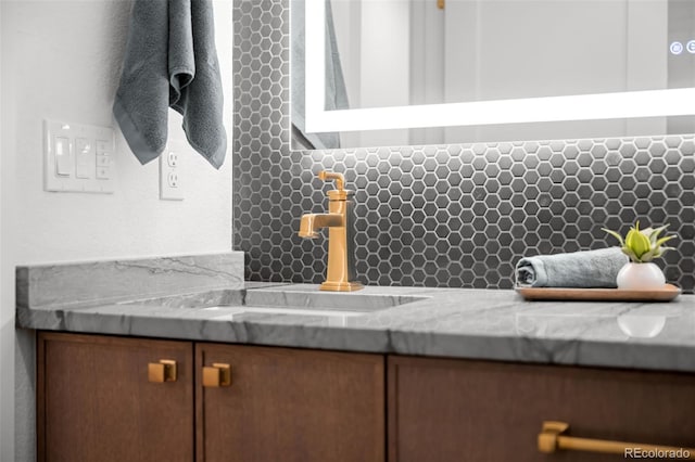 bathroom view of backsplash and a sink
