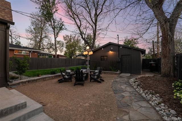 yard at dusk with a fenced backyard, a patio area, and outdoor dining area