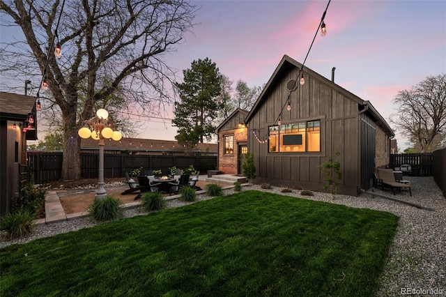 rear view of property featuring board and batten siding and a patio area