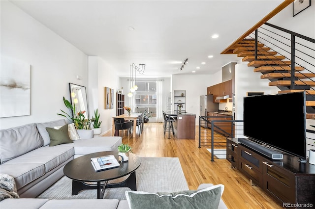 living area featuring light wood finished floors and recessed lighting