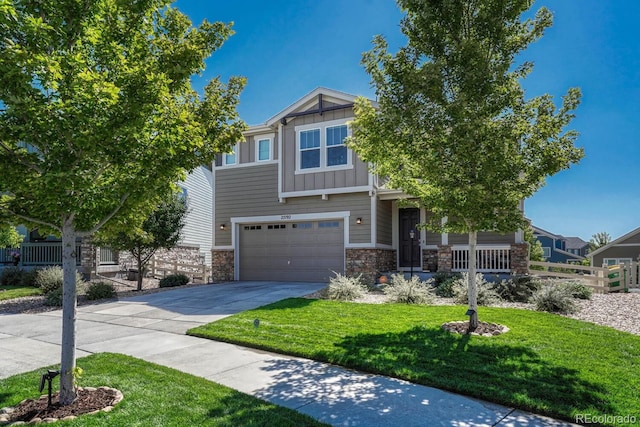 craftsman inspired home featuring a front yard and a garage