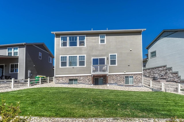 rear view of property featuring a yard