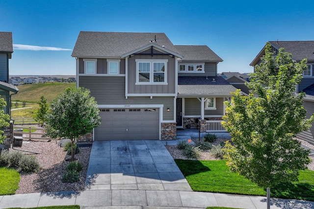 craftsman inspired home with a porch and a garage