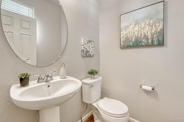 bathroom with toilet and sink