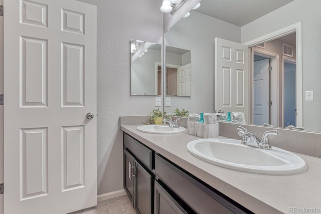 bathroom with vanity and tile patterned floors