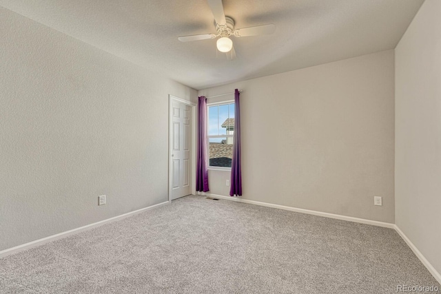 spare room with ceiling fan and carpet floors