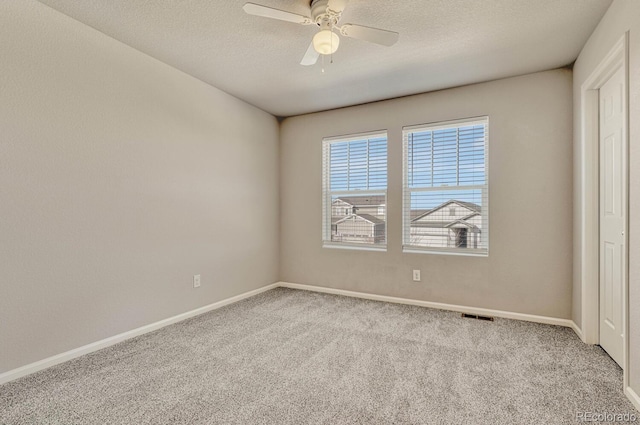 unfurnished bedroom featuring ceiling fan, light colored carpet, and a textured ceiling