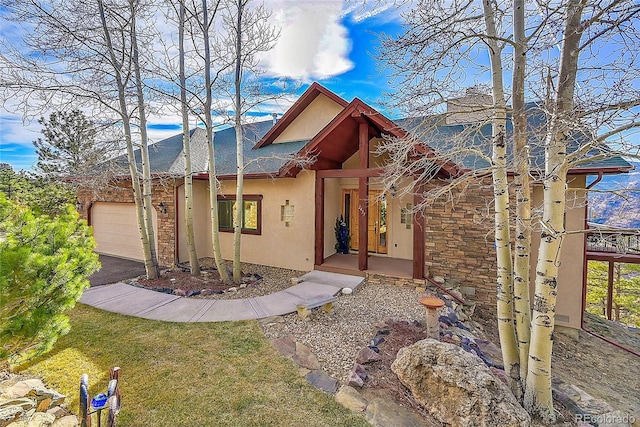 2433 Dogie Spur, Golden, CO 80403 - view of front of property featuring stucco siding, an attached garage, and driveway