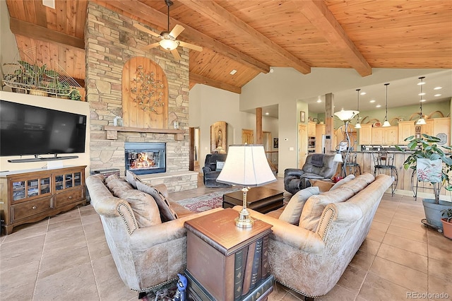 2433 Dogie Spur, Golden, CO 80403 - living room with a ceiling fan, wooden ceiling with exposed beams, light tile patterned floors, a stone fireplace, and recessed lighting