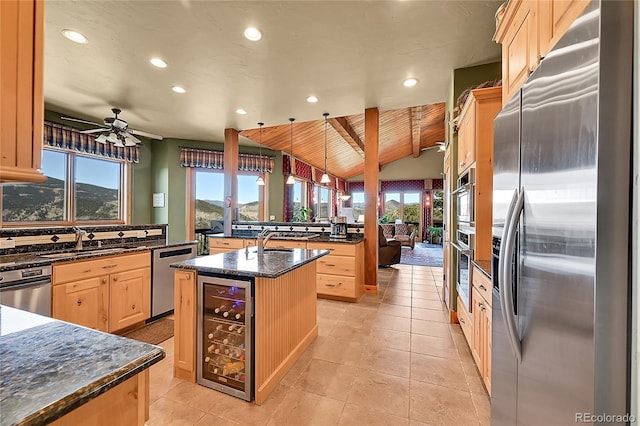2433 Dogie Spur, Golden, CO 80403 - kitchen featuring stainless steel appliances, wine cooler, light brown cabinetry, a sink, and an island with sink