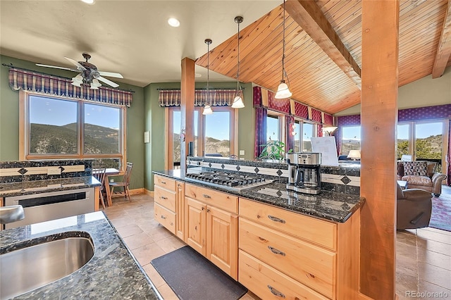 2433 Dogie Spur, Golden, CO 80403 - kitchen with stainless steel gas stovetop, light brown cabinetry, a ceiling fan, a sink, and dark stone countertops