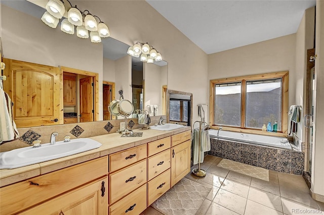 2433 Dogie Spur, Golden, CO 80403 - full bathroom with a garden tub, double vanity, and tile patterned floors