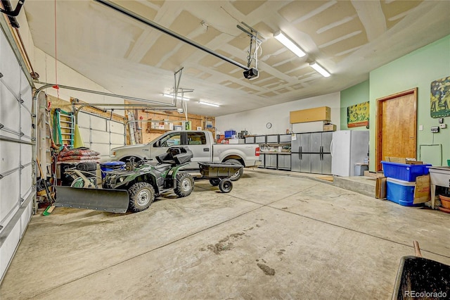 2433 Dogie Spur, Golden, CO 80403 - garage with a garage door opener and freestanding refrigerator