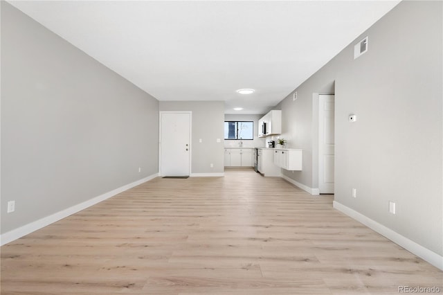 unfurnished living room featuring light hardwood / wood-style flooring