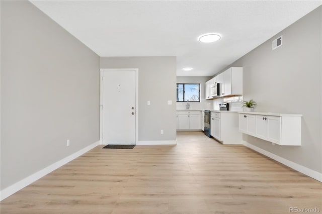 interior space featuring sink and light hardwood / wood-style floors