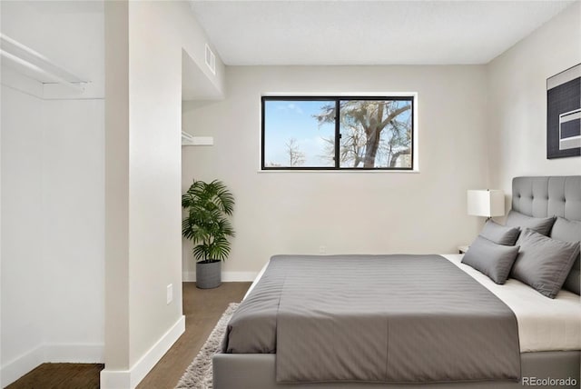 bedroom with dark wood-type flooring