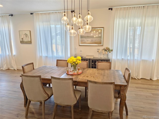 dining area featuring an inviting chandelier and light hardwood / wood-style flooring