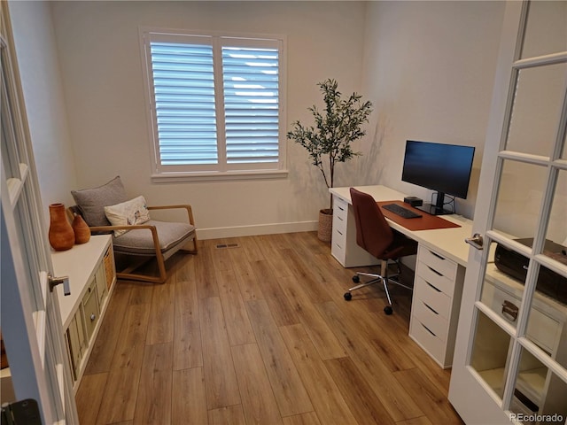 office area with light hardwood / wood-style floors