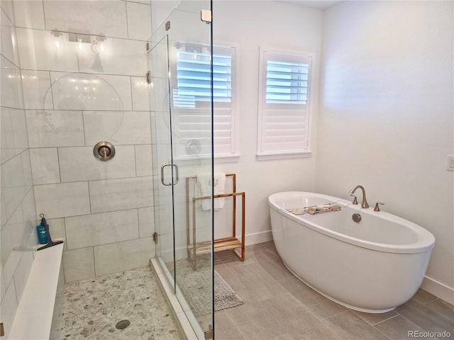 bathroom featuring independent shower and bath