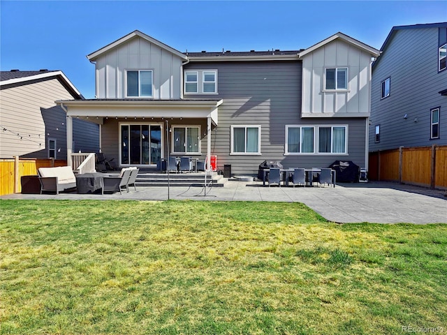 back of house featuring a yard and a patio