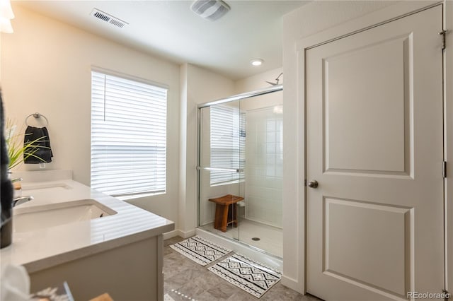 920 William Way, Brighton, CO 80603 - full bath featuring a shower stall, double vanity, and baseboards