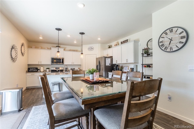 920 William Way, Brighton, CO 80603 - dining space with dark wood-type flooring, baseboards, and recessed lighting