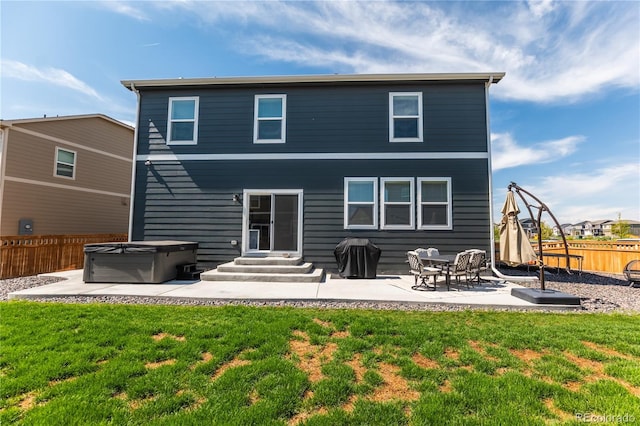 920 William Way, Brighton, CO 80603 - back of house with a hot tub, a patio area, and entry steps