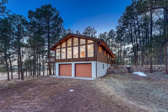 view of property exterior featuring a garage and driveway