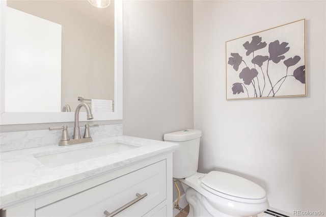 bathroom with vanity with extensive cabinet space and toilet