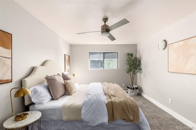 bedroom featuring a baseboard heating unit, carpet flooring, and ceiling fan