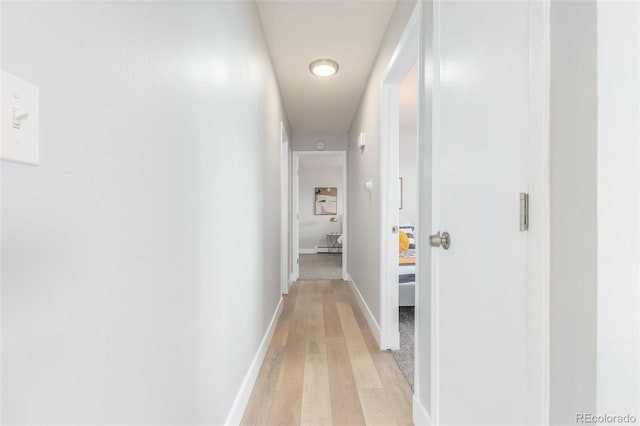 hallway with light hardwood / wood-style floors