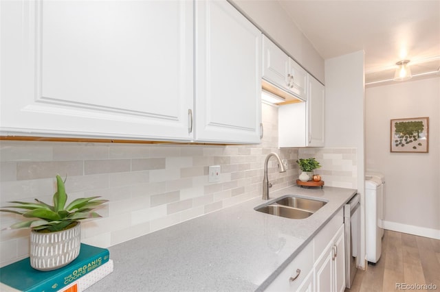 kitchen with white cabinetry, sink, tasteful backsplash, and wood-type flooring