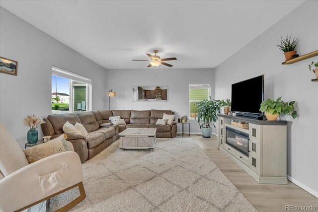 7218 Animas Ave, Frederick, CO 80530 - living area featuring light wood finished floors, ceiling fan, and baseboards