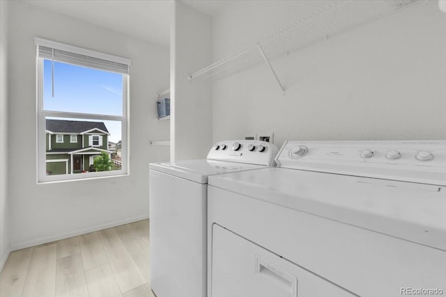 7218 Animas Ave, Frederick, CO 80530 - washroom with separate washer and dryer, light wood-style flooring, and baseboards