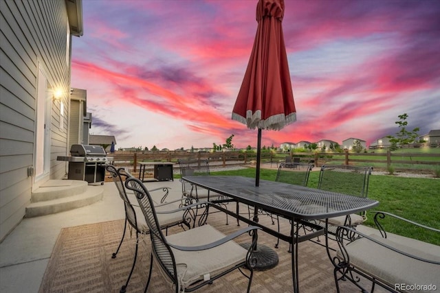 7218 Animas Ave, Frederick, CO 80530 - patio terrace at dusk with grilling area, outdoor dining space, and a patio