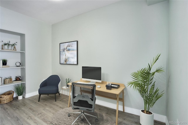 home office featuring baseboards and wood finished floors