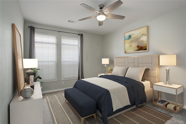 carpeted bedroom featuring baseboards, visible vents, and a ceiling fan