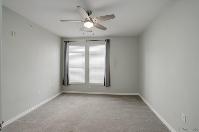 spare room with carpet floors, baseboards, and a ceiling fan