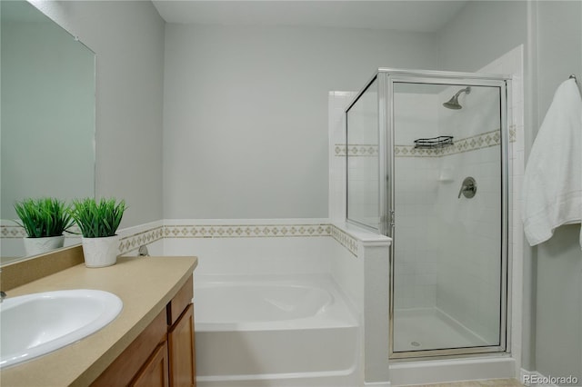 bathroom with a stall shower, a garden tub, and vanity