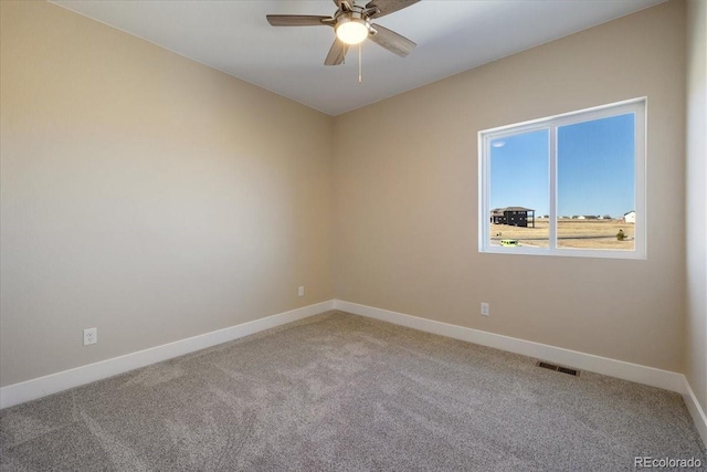 spare room with ceiling fan and carpet