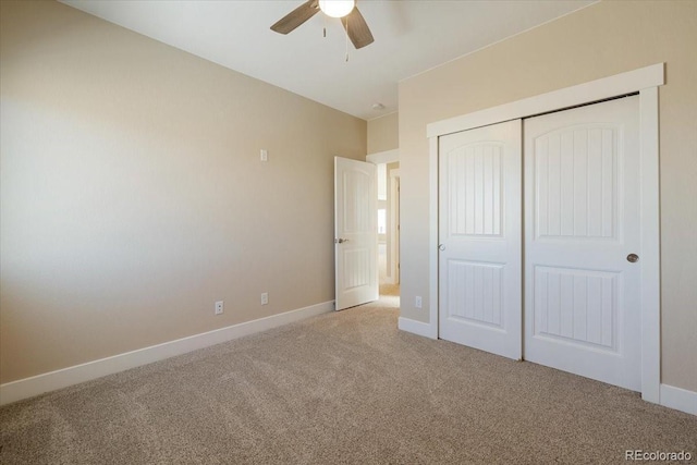 unfurnished bedroom with light colored carpet, ceiling fan, and a closet