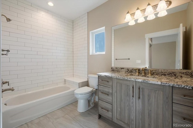 full bathroom with vanity, toilet, and tiled shower / bath combo